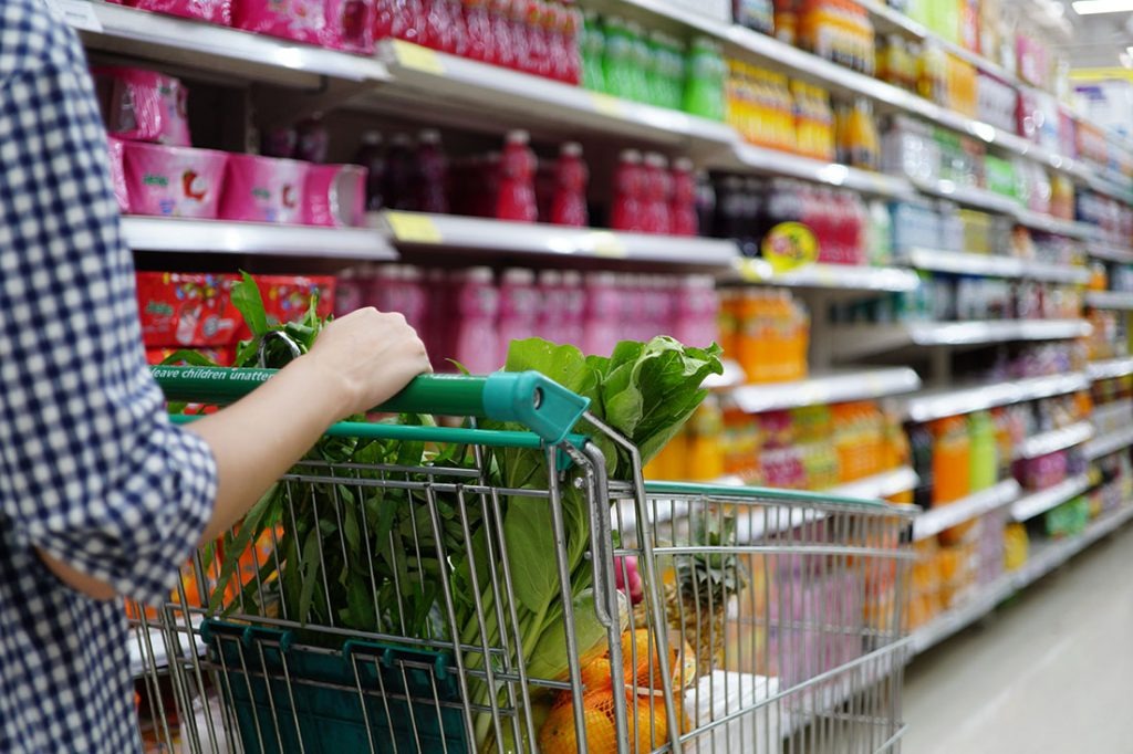 imgi 212 women pushing shopping trolly in the supermarket aisles shopping concept 1024x682